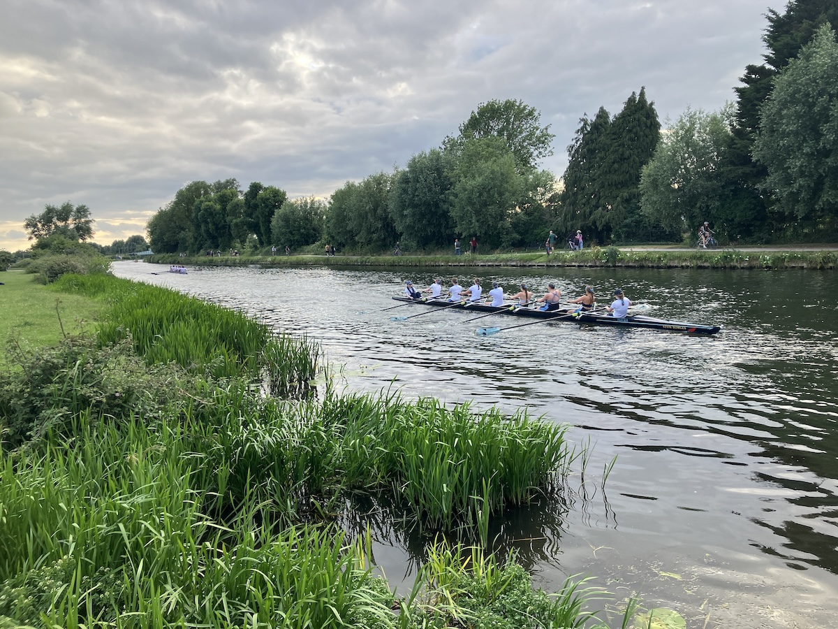 An 8-person rowing boat sails on the river in Cambridge, England. Taken by James Mead.